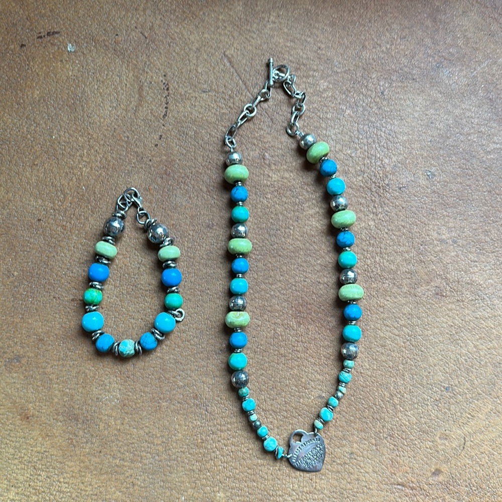Necklace and bracelet set. Has a Tiffany and Company charm.